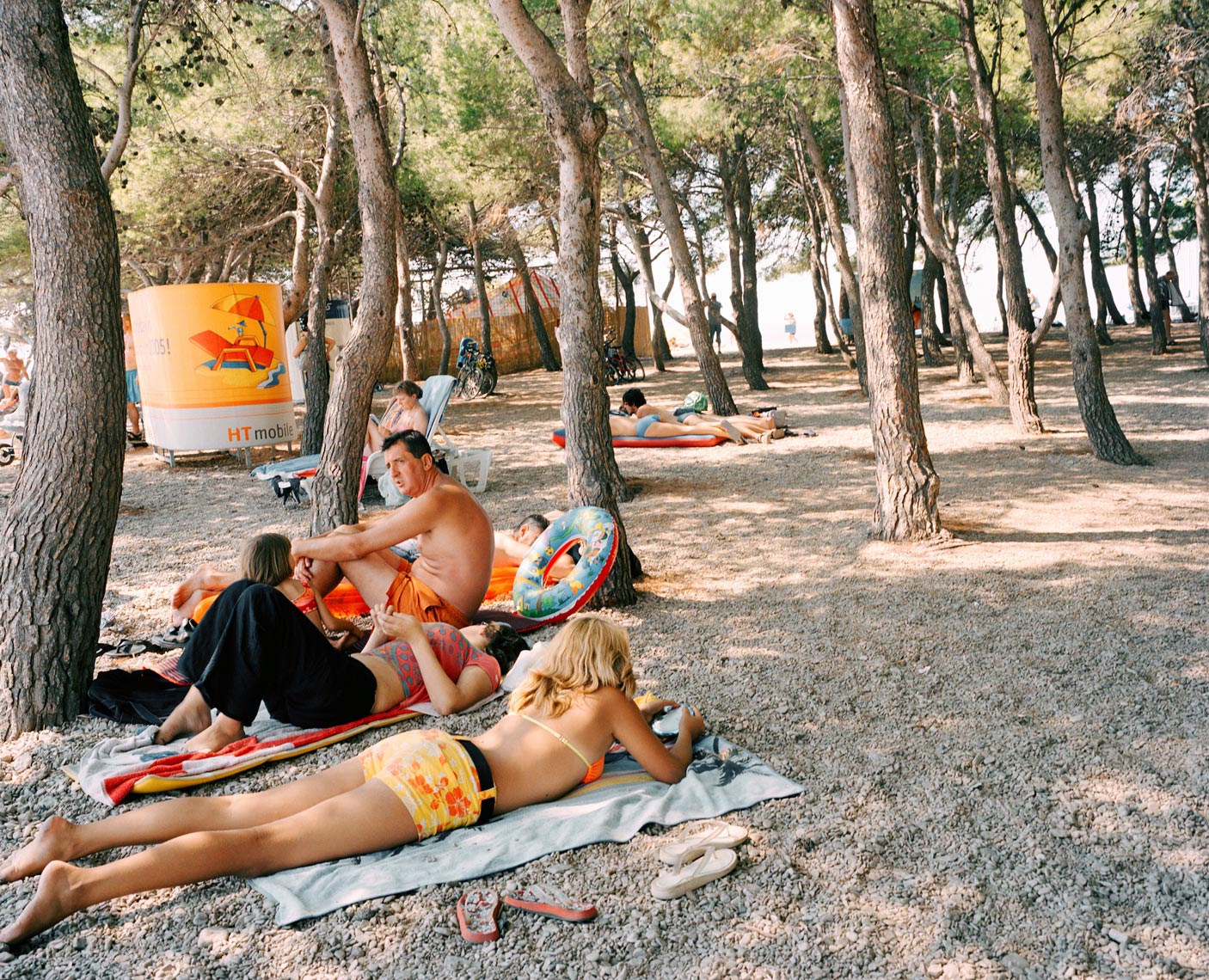 CROATIA, Dalmatian coast, people relaxing on beach at Hvar