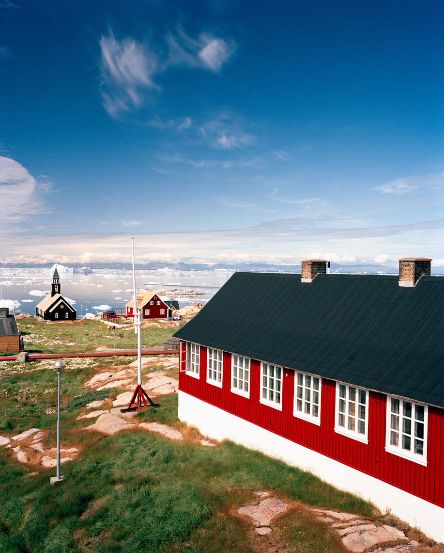 GREENLAND, Ilulissat, Disco Bay, exterior of houses with church