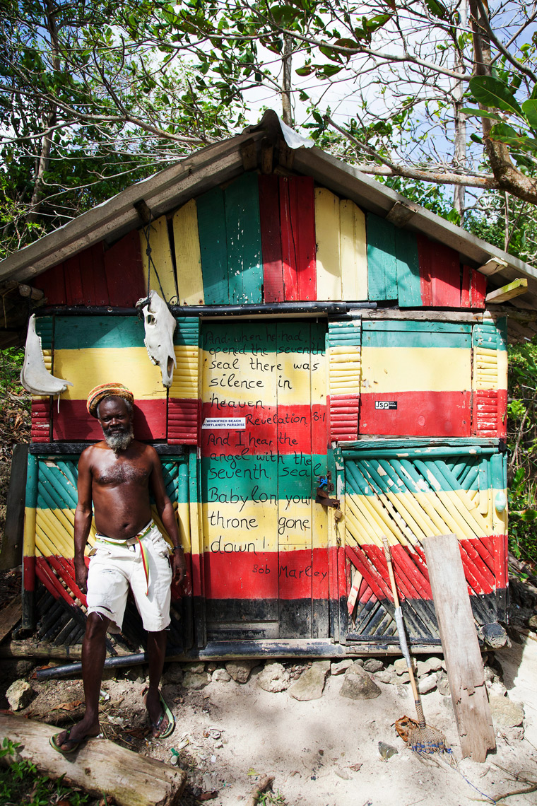 JAMAICA, Port Antonio. A rastafari and his beach shack at the Winnifred Beach.