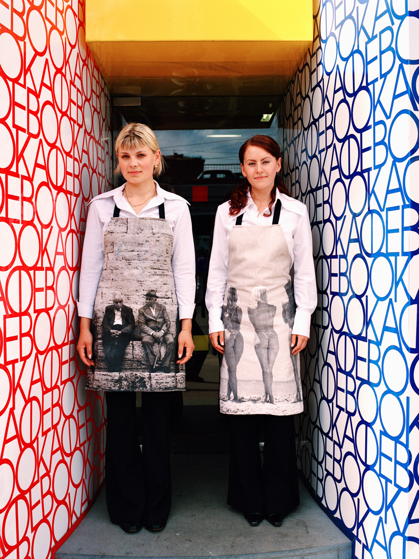 RUSSIA, Moscow, young waitresses at the front door of the Book Cafe.