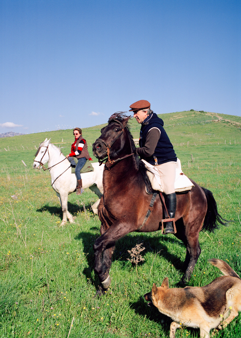 SPAIN, Andalusia, Tarifa, mature man and woman riding horse on hill