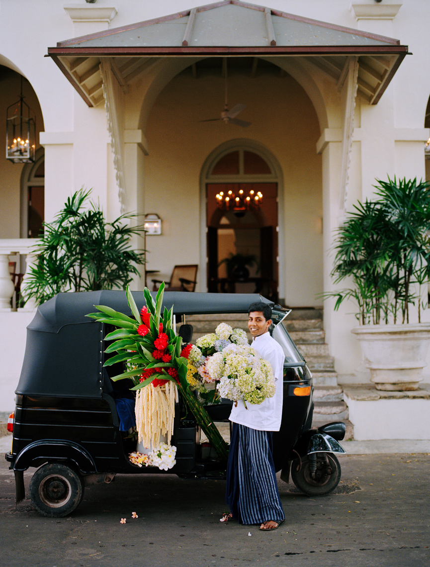 SRI LANKA, Asia, Galle, portrait of hotel staff holding flowers in front of the Amangalla Hotel in Galle.