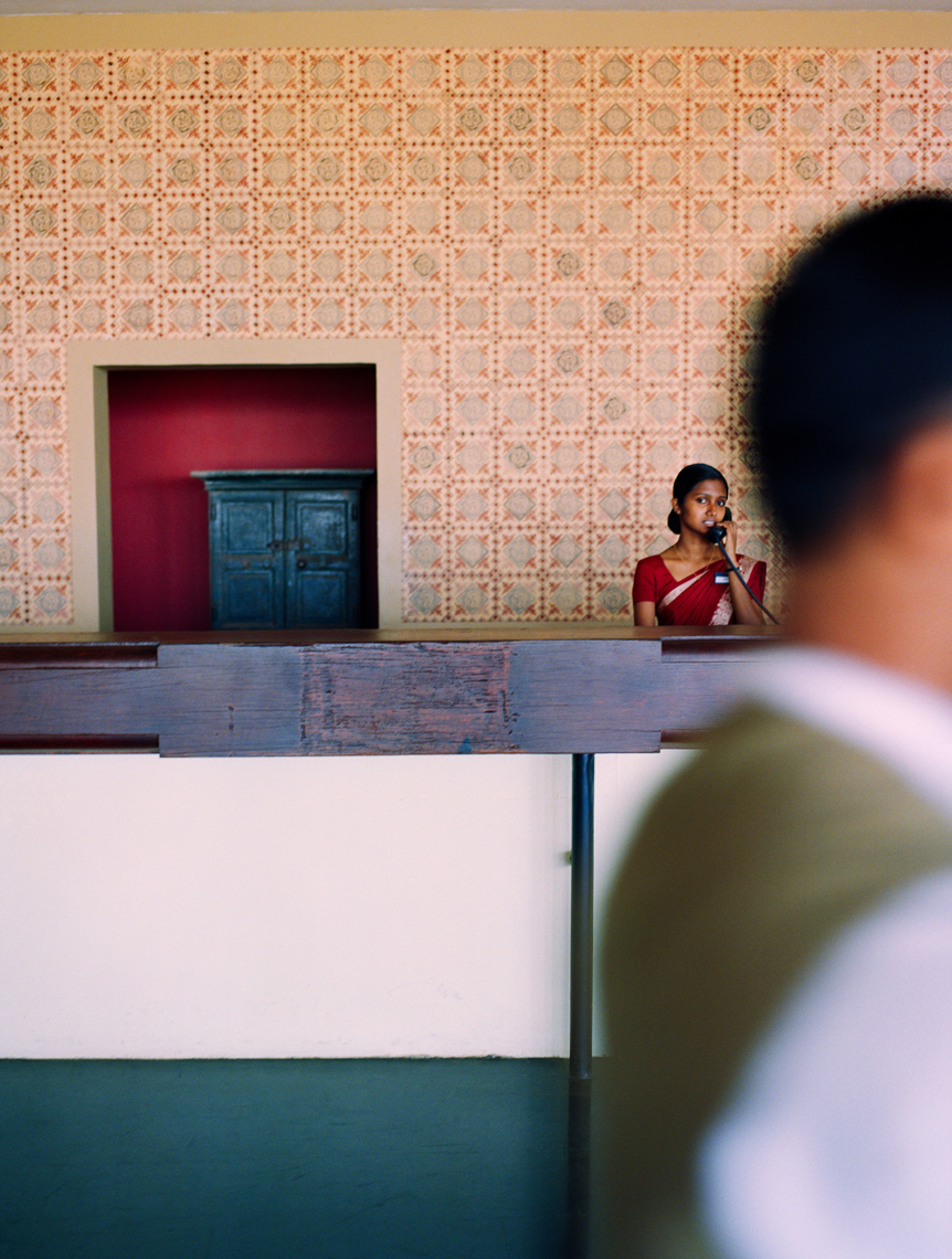 SRI LANKA, Asia, Dambulla, female receptionist talking on phone at Kandalama Hotel